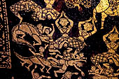 Wat Xieng Thong temple in Luang Prabang, Laos. Detail of the  intricate gold stencilling on black lacquer that decorate the walls of the sim. 